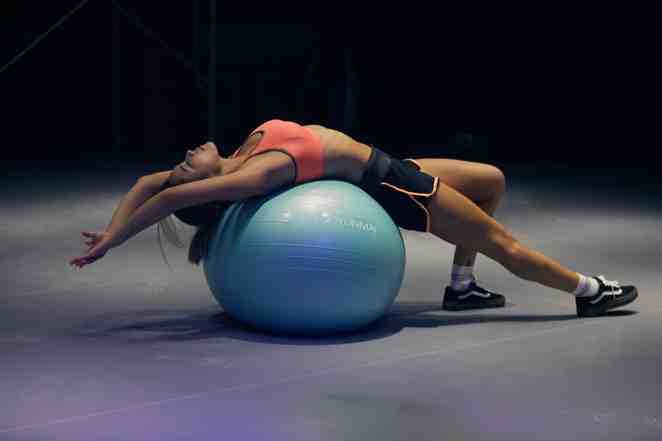 Woman doing yoga on a fitness ball