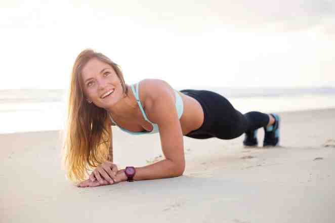 Woman Exercising On Beach